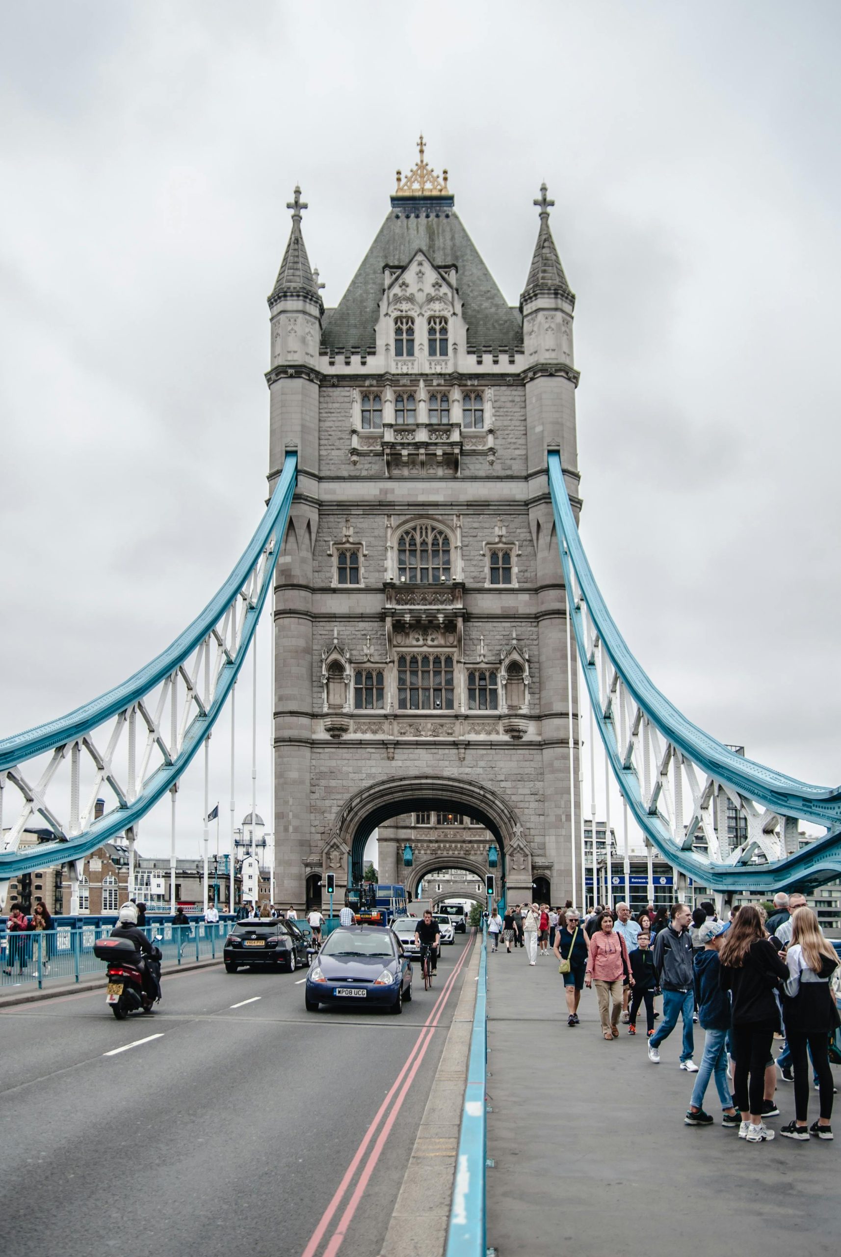 View of Tower Bridge in London, showcasing its iconic architecture and bustling scene with visitors.